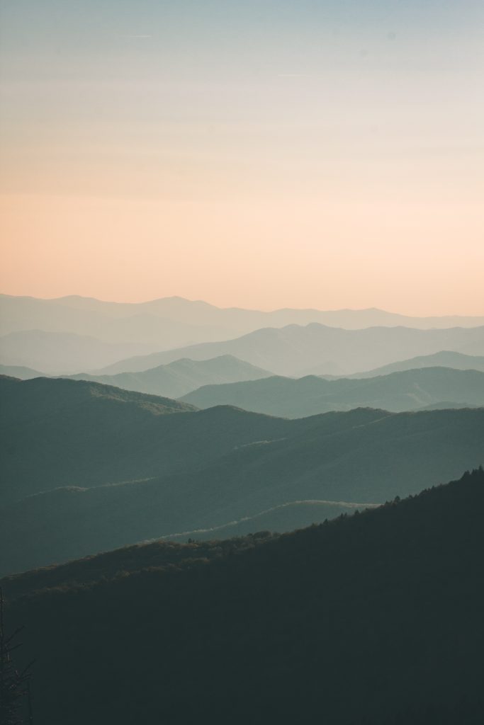 mountains under white mist at daytime