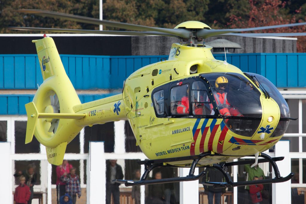 Medical rescue helicopter flying above the Dutch Wadden Islands during HEMS operations.