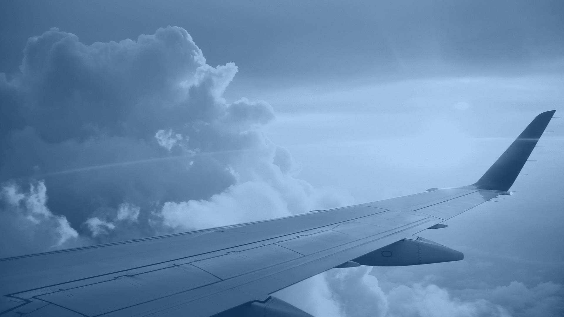 Airplane wing above clouds illustrating flight procedure design