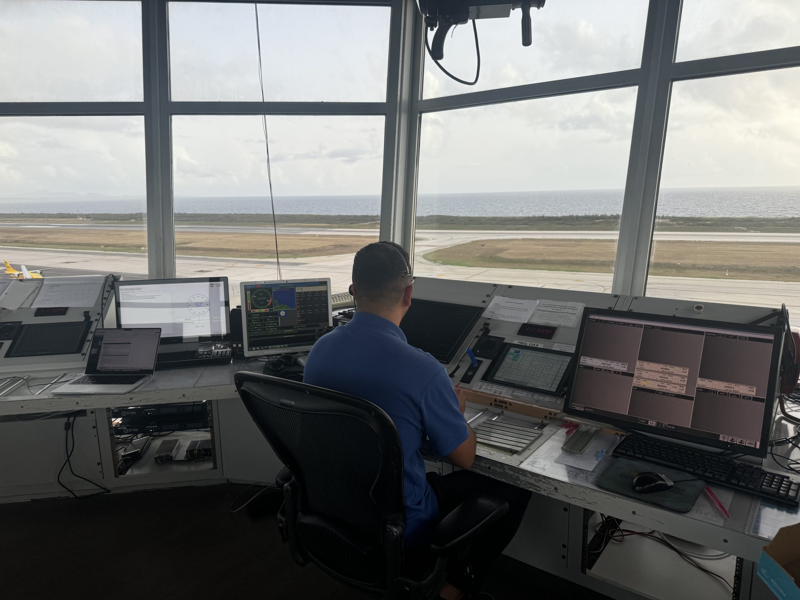 Air traffic controllers collaborating in an operations room focused on human performance and safety.